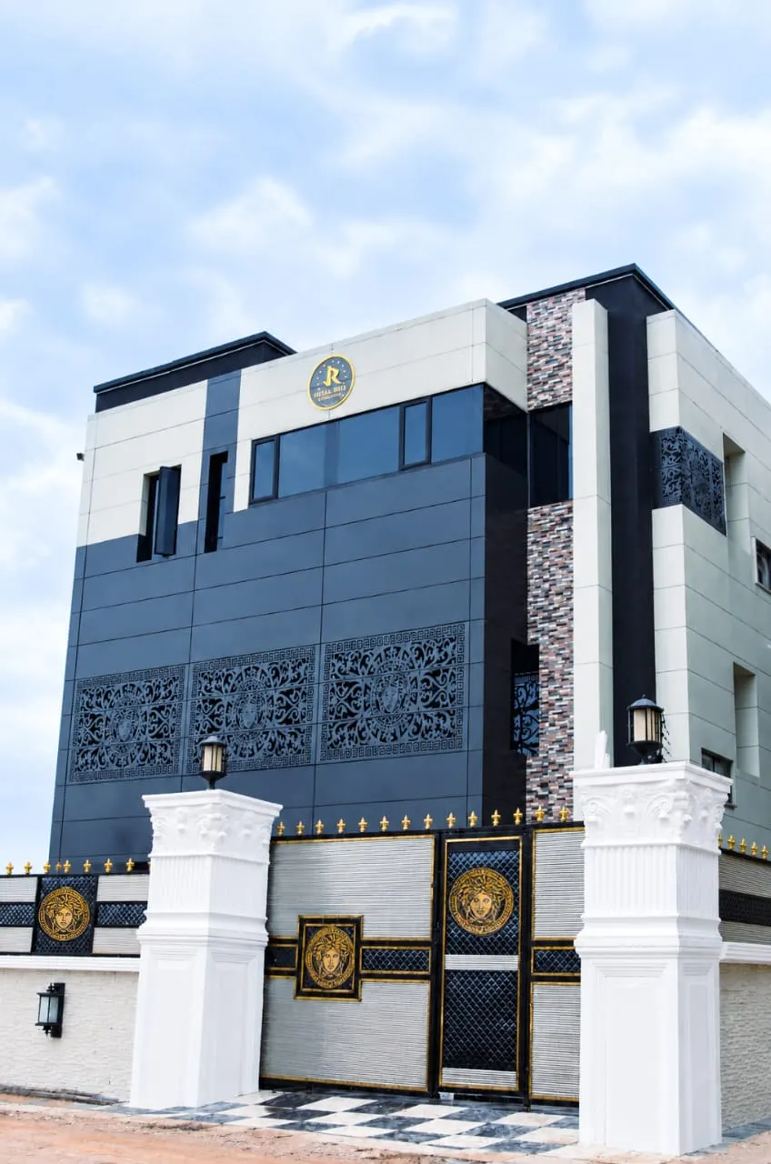 Tall view of the Juls & Riff Lagos building and its black and gold gate