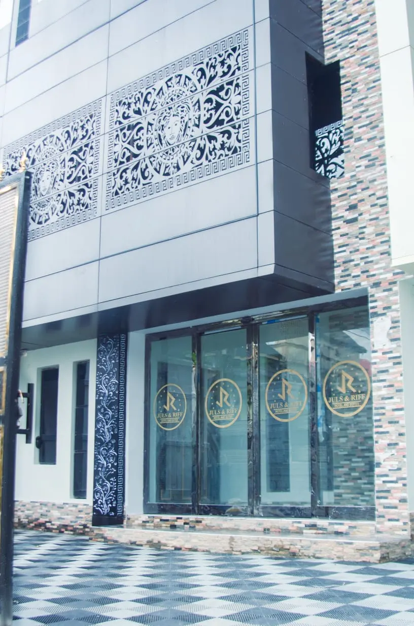Glass entrance doors of Juls & Riff Lagos, each panel carrying the gold Juls & Riff Hotel and Suites emblem