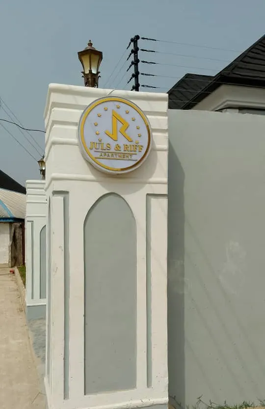 Gate pillar with a Juls & Riff Apartment sign at the Abeokuta property, which is still being completed